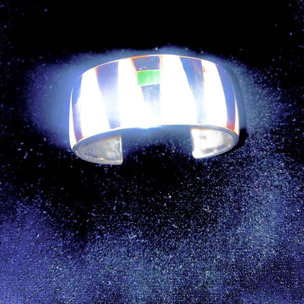 Bracelet metal inlaid with mother of pearl and something. White and black